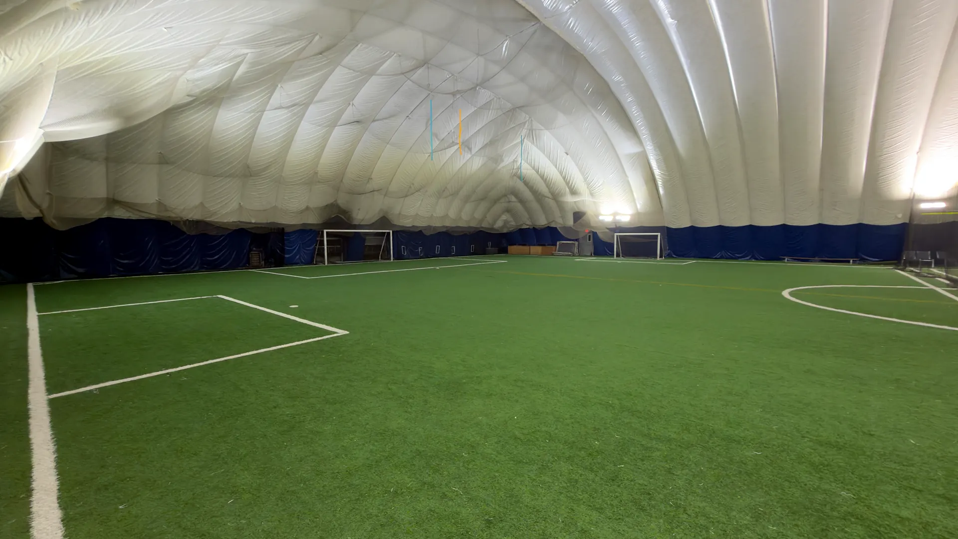 Inside the Toronto City Sports Centre dome, a lit indoor turf field