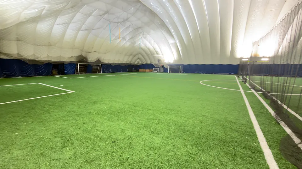 The TCSC turf field with a divider net along halfway, so two games can run side by side